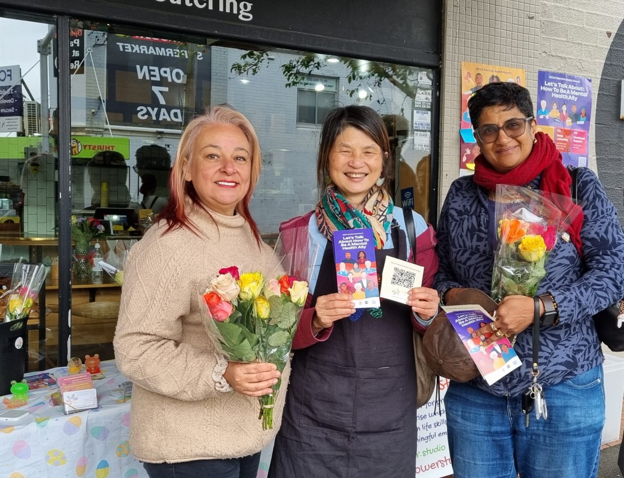 Community Flower Studio volunteers gifting bouquets to community members